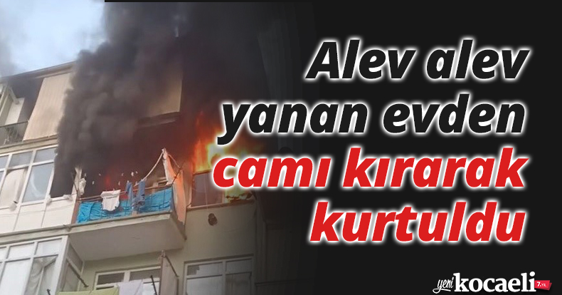 Alev alev yanan evden camı kırarak kurtuldu