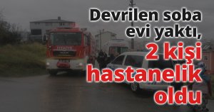 Devrilen soba evi yaktı, 2 kişi hastanelik oldu