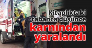 Kitaplıktaki tabanca düşünce karnından yaralandı